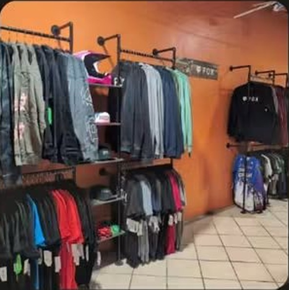 Wall of FOX Racing apparel and jerseys on display